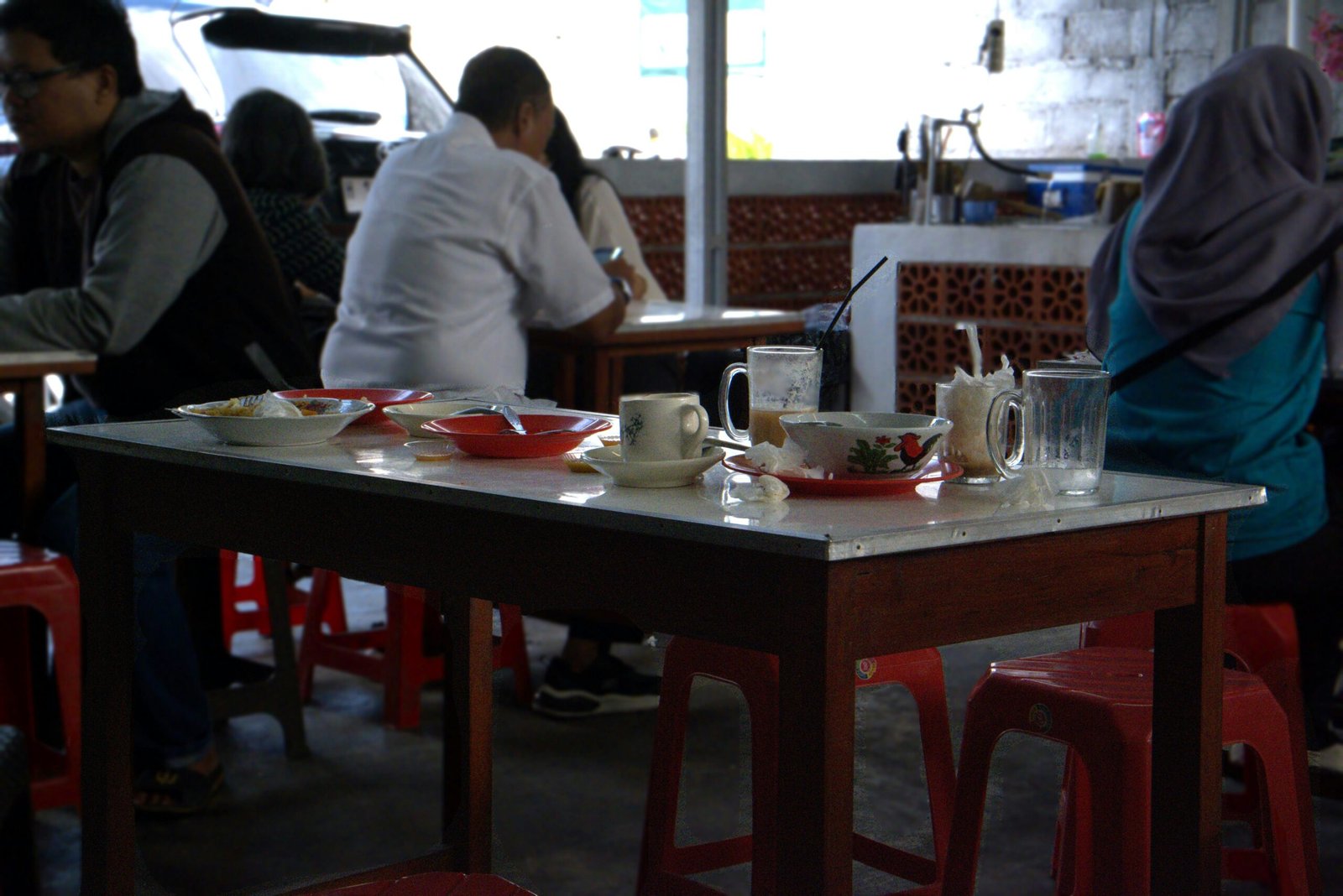 a group of people sitting at a table in a restaurant